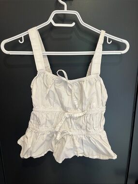 White ruffled top with bows
